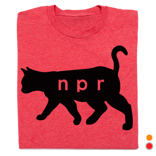 A folded heather red t-shirt featuring a black cat silhouette with the letters 'npr' printed in red across its body, shown on a white background with two small color indicator dots in the bottom right corner.