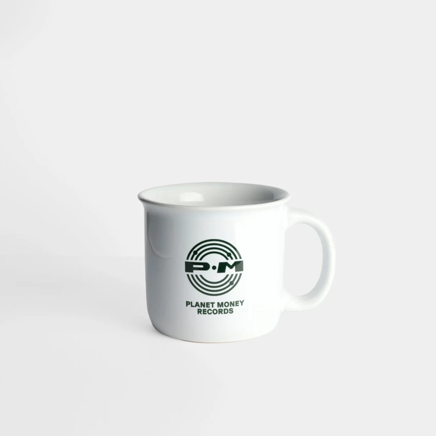 White mug with green Planet Money design