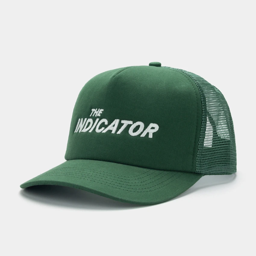 Green trucker hat with a mesh back and the indicator podcast logo