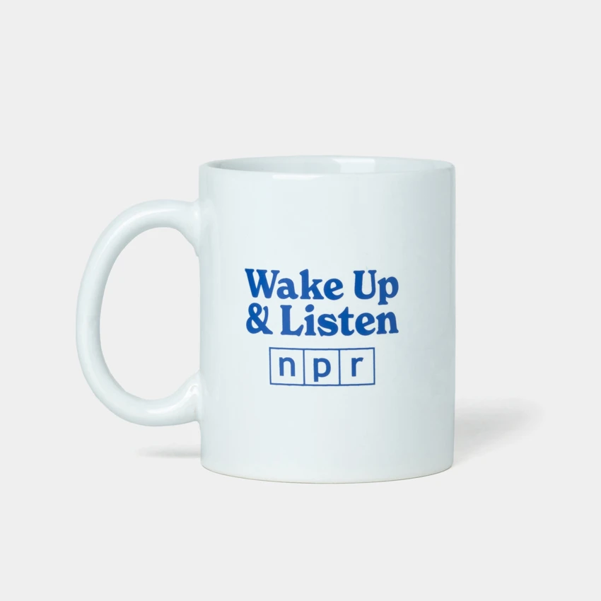 White mug with NPR logo and wake up and listen design