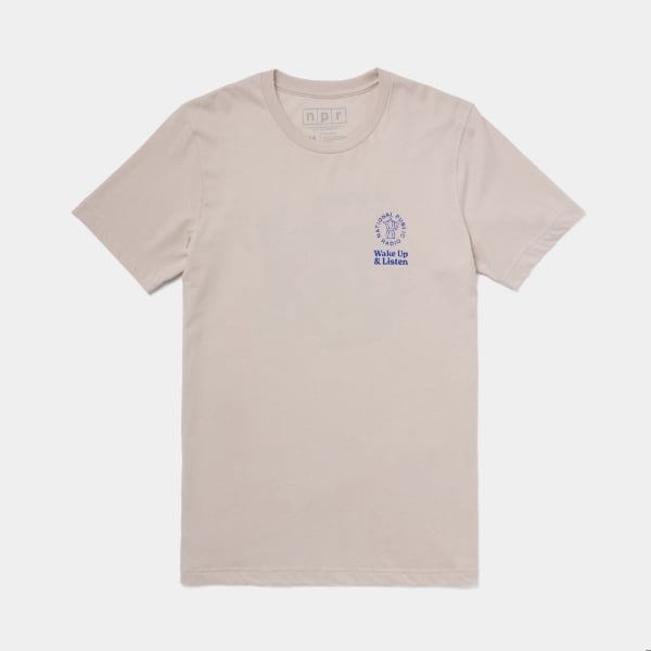 A light beige t-shirt with a small blue NPR logo and the text "Wake Up & Listen" on the front.