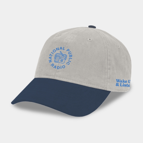 Blue and grey hat with the NPR Wake Up & Listen design embroidered on the front